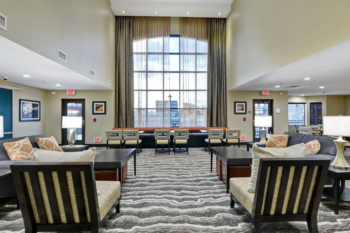 A bright, spacious lounge area with large windows, comfortable seating, and decorative touches. The arrangement encourages families to gather, relax, and enjoy the view—an ideal transition between outdoor activities and indoor comfort.